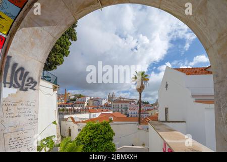 View through an archway and across the rooftops of houses in the centre of Lisbon, capital city of Portugal Stock Photo
