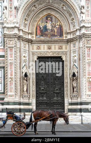 Typical horse-drawn carriage in Duomo square, in front of Florence cathedral, Florence city center, Tuscany region, Italy Stock Photo