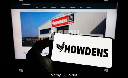 Cellphone with logo of British company Howden Joinery Group plc on