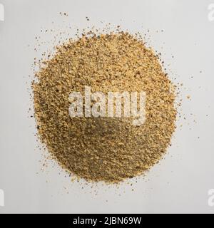 pile of ground horse gram, macrotyloma uniflorum, tropical south asian legume most protein rich lentil, isolated neutral gray background Stock Photo