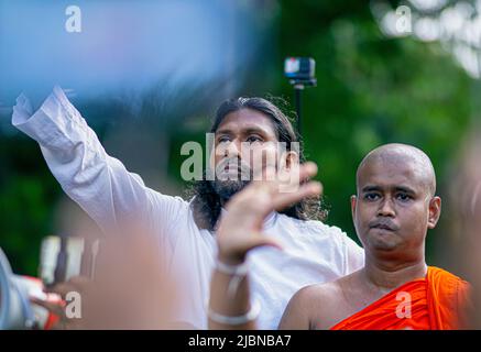 A poor man in Sri Lanka holds the national flag in his hand Stock Photo