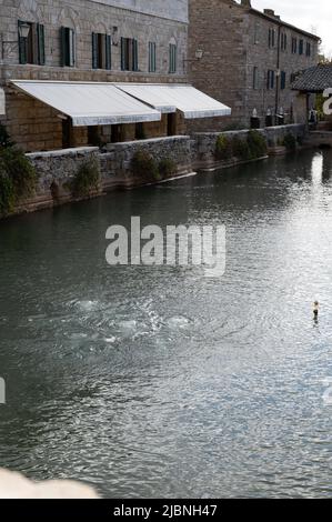 Ancient natural hot springs stone pool in small Italian village Bagno Vignoni in Tuscany Stock Photo