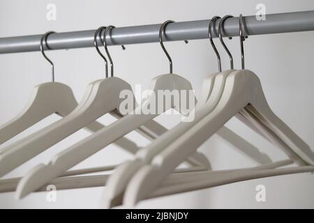 empty white wooden rods hung on tube Stock Photo