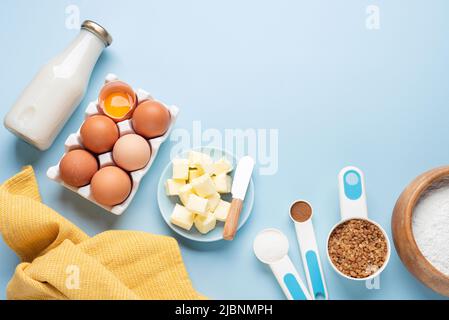Baking ingredients for sweet bread, cake or cookies on a blue background. Top view copy space Stock Photo
