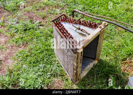 Old rusty air conditioner outdoor unit ready for replacement Stock Photo