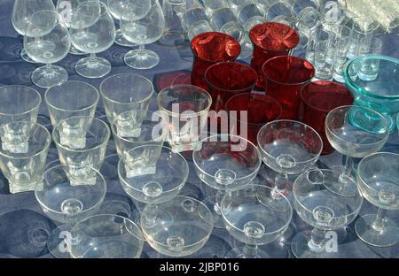 collection of many rare very fragile vintage style glass glasses and wine goblets for sale in flea market Stock Photo