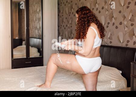 Premium Photo  Curly plus size woman in white underwear stand
