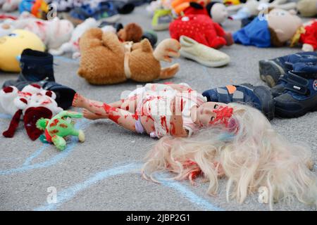 Ljubljana, Slovenia. 07th June, 2022. Children dolls stained with red paint lay on the ground during a Europe-wide rally for protection of Ukrainian children affected by the war in Ukraine. Over 240 children have been reported killed in the war so far. Credit: SOPA Images Limited/Alamy Live News Stock Photo