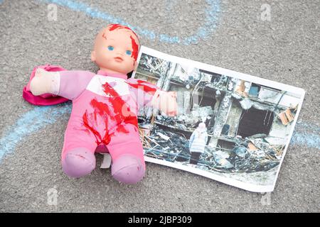 Ljubljana, Slovenia. 07th June, 2022. A child's doll stained with red paint lays on the ground during a Europe-wide rally for protection of Ukrainian children affected by the war in Ukraine. Over 240 children have been reported killed in the war so far. (Photo by Luka Dakskobler/SOPA Images/Sipa USA) Credit: Sipa USA/Alamy Live News Stock Photo