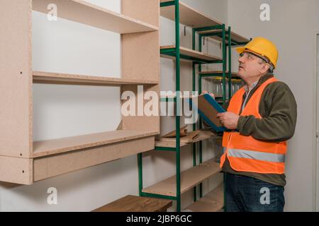 Caucasian inspector supervising the safety of a retailer's site and facilities. Stock Photo