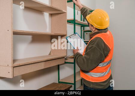 Caucasian inspector supervising the safety of a retailer's site and facilities. Stock Photo