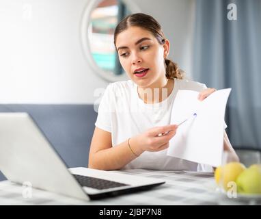 Distance learning concept. Woman using laptop studying Stock Photo