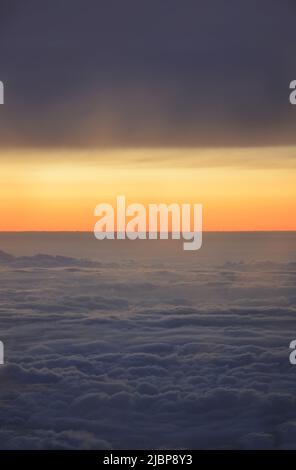 Sunset as seen from above the clouds Stock Photo