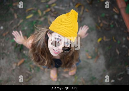 Woman outdoor looking at the camera wearing yellow clothes and fashion sunglasses Stock Photo