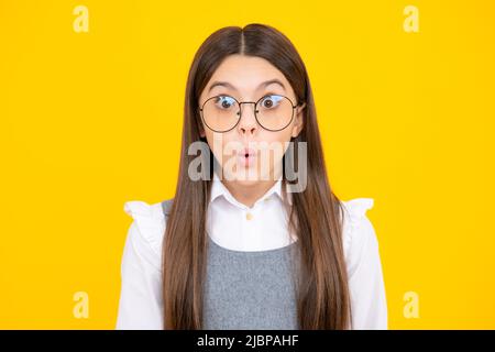 Studio shot of emotional adorable little girl surprised and shocked, showing true astonished reaction on unexpected news. Funny teenager child girl Stock Photo