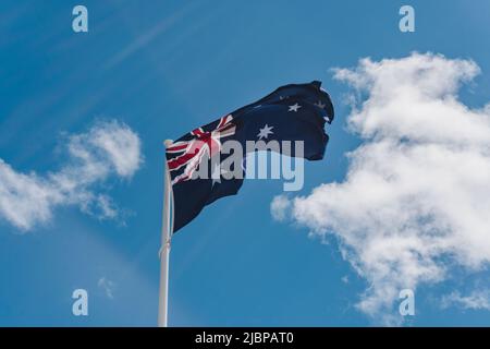 BUSSELTON, Australia. Australian flag waving in wind agains blue sky on a summer day Stock Photo