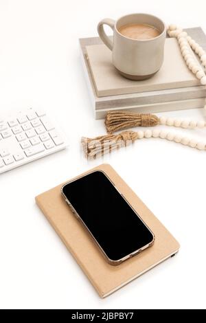 Minimalist Boho Styled Desk Workspace with a Cell Phone for Mockup Stock Photo