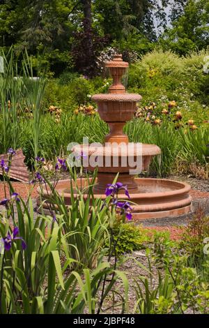 Cascading terracotta water fountain at the Route des Gerbes d'Angelica garden in spring, Mirabel, Quebec, Laurentians, Canada. Stock Photo