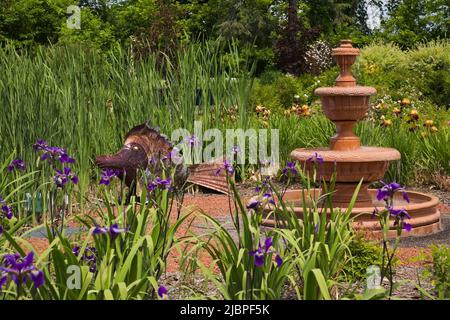 Cascading terracotta water fountain at the Route des Gerbes d'Angelica garden in spring, Mirabel, Quebec, Laurentians, Canada. Stock Photo