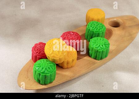 Colorful Snow Skin Moon Cake, Sweet Snowy Mooncake, Traditional Sweet Dessert for Mid Autumn Festival on Bright Rustic Background. Copy Space Stock Photo