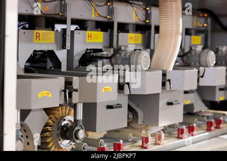 Close up of industrial woodworking brush sanding machine. Selective focus. Stock Photo