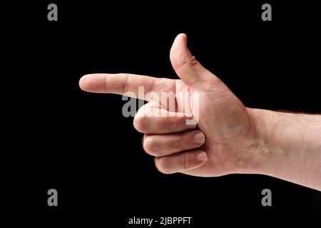 Shoting gesture, male hand on black background. Stock Photo
