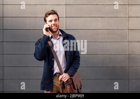 smiling caucasian businessman talking on the phone Stock Photo