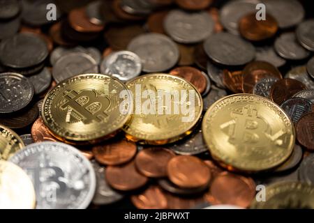 A pile of coins, US dollar coins next to Crypto coins. Gold and silver Bitcoins on top of copper pennies. Digital currency concept. trading USD with B Stock Photo