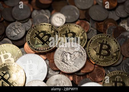 A pile of coins, US Dollar coins next to Crypto coins. Gold and Silver Bitcoins. Digital Currency concept. Trading USD with BTC Stock Photo