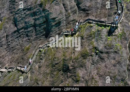 (220608) -- WUYISHAN, June 8, 2022 (Xinhua) -- Aerial photo taken on June 6, 2022 shows tourists visiting Mount Wuyi in southeast China's Fujian Province. Mount Wuyi, located in China's southeast province of Fujian, is a landscape of great beauty, in which the peaks and rocks of grotesque shapes are girded by clear streams and embraced by green trees and bamboo plants. Acting as a habitat for a large number of wildlife, it is of enormous importance for biodiversity conservation. There are a series of exceptional archaeological sites at Mount Wuyi, including the remains of ancient Han Dynast Stock Photo