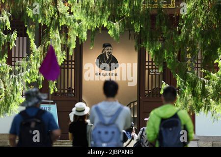 (220608) -- WUYISHAN, June 8, 2022 (Xinhua) -- Tourists visit a park dedicated to Zhu Xi, a renowned Chinese philosopher in the 12th century, in Mount Wuyi in southeast China's Fujian Province, June 6, 2022. Mount Wuyi, located in China's southeast province of Fujian, is a landscape of great beauty, in which the peaks and rocks of grotesque shapes are girded by clear streams and embraced by green trees and bamboo plants. Acting as a habitat for a large number of wildlife, it is of enormous importance for biodiversity conservation. There are a series of exceptional archaeological sites at Mo Stock Photo