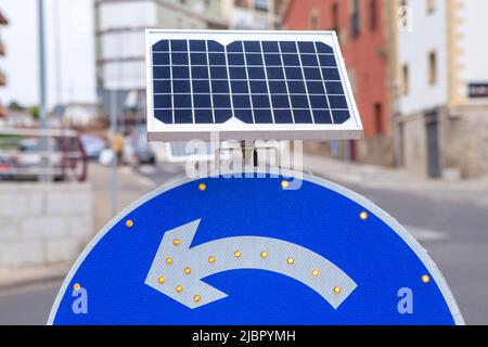 Roundabout sign powered by solar panel. Environmentally friendly traffic signs Stock Photo