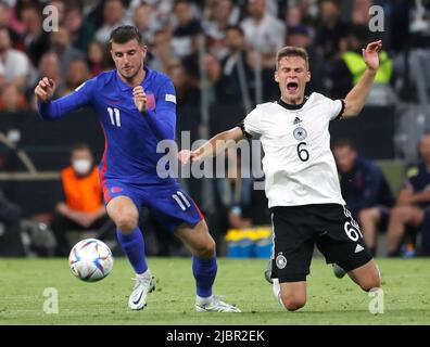 Munich, Germany. 7th June, 2022. Germany's Joshua Kimmich (R) vies with England's Mason Mount during their UEFA Nations League A football match at the Allianz Arena in Munich, Germany on June 7, 2022. Credit: Philippe Ruiz/Xinhua/Alamy Live News Stock Photo