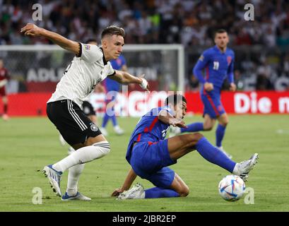 Munich, Germany. 7th June, 2022. Germany's Nico Schlotterbeck (L) vies with England's Jude Bellingham during their UEFA Nations League A football match at the Allianz Arena in Munich, Germany on June 7, 2022. Credit: Philippe Ruiz/Xinhua/Alamy Live News Stock Photo