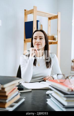 Account balance definition. Female Accountant working with many books and notepads Stock Photo