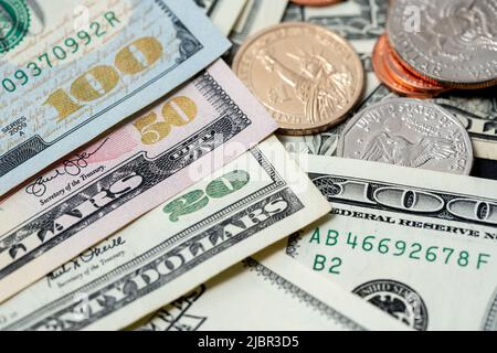 US Dollar Banknotes with shiny denomination numbers, Banknotes next to Dollar coins, 1 Dollar and Half Dollar coin Stock Photo
