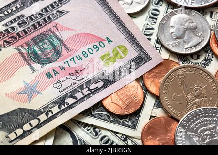 Fifty Dollar Banknote next to one Dollar Coins. US Currency, paper money and coins. USA Economy and Trade Stock Photo