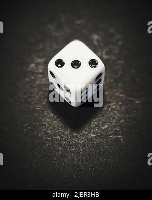 dice with the number three on a black background Stock Photo