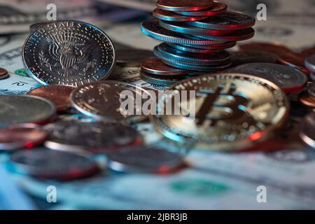 Bitcoin on top of USD coins, half Dollar coins and Banknotes. Crypto currency and Fiat currency. Blockchain and trade concept Stock Photo