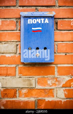 blue mailbox on a brick wall, russian post, russia flag, background Stock Photo