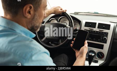 Back View Of Male Driver Using Phone Driving Car, Panorama Stock Photo