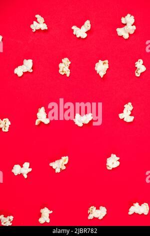 Popcorn on a red background, close-up view from above Stock Photo