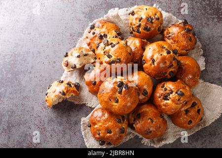 Homemade freshly baked buns with raisins and currants close-up on the table. horizontal top view from above Stock Photo