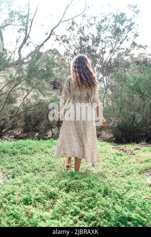 Bohemian girl wearing maxi dress in forest garden Stock Photo