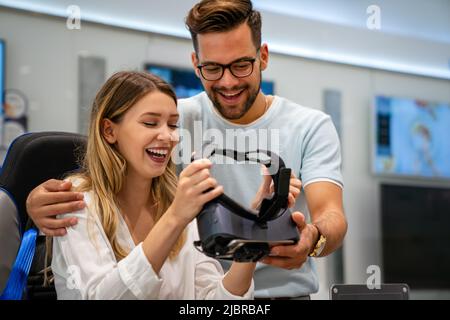 Group of people using virtual reality headset at exhibition, show. VR technology simulation concept Stock Photo