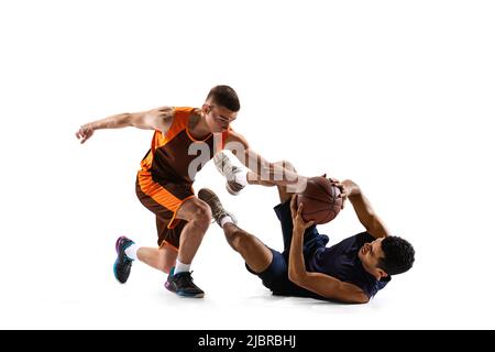 Dynamic portrait of two professional basketball players in motion, training isolated over white studio background Stock Photo