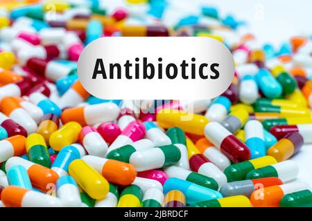 Pile of multi-colored antibiotics capsule pills. Antibiotic drug resistance concept. Prescription drugs. Superbug concept. Antibiotic drug use with re Stock Photo