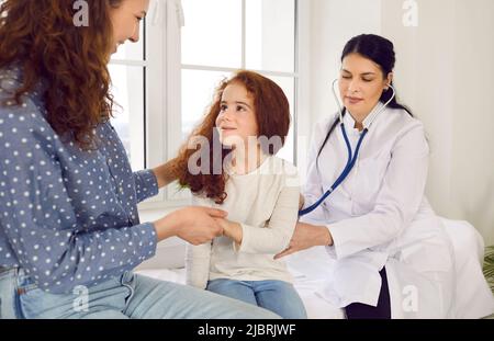 Little girl at the family doctor. lung area examined with