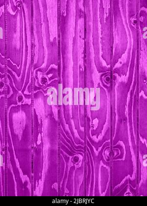 Vertically aligned pink wooden boards with intense grain as background Stock Photo