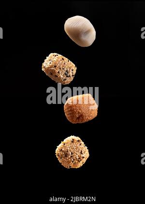 flying pieces of japanese dessert mochi. Japanese ice cream Mochi in rice dough. Stock Photo